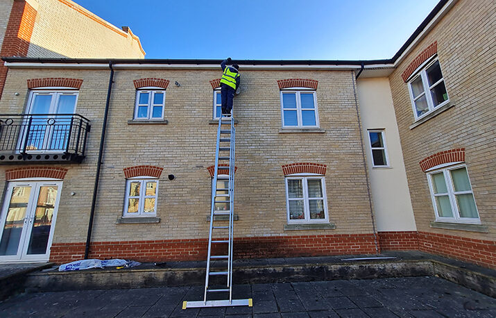 gutter repair man on ladder